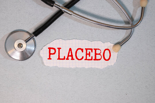 placebo wording or text on wooden block with brown wooden background with pills
