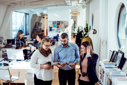 Designers reviewing print proofs in open plan studio