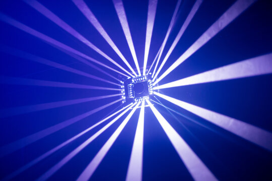 Symmetric White Light Beams Radiating from a Central Lighting Fixture in a Dark Indoor Music Venue with Copy Space With blue Background