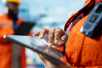 Close up of offshore platform worker supervising deck operations with device, ensuring compliance...