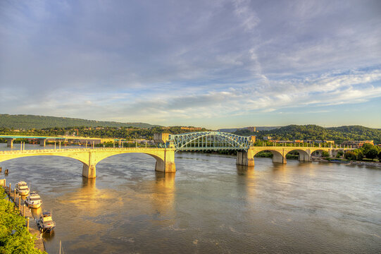 Chef John Ross Bidge. A large bridge over the Tennessee River, spans a wide, calm river, connecting two lush, green landscapes on either side.