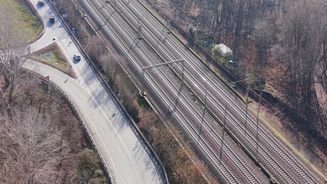 Railway Tracks: An elevated perspective captures the intricate network of railway tracks weaving through the landscape, alongside a road, highlighting the intersection of transport
