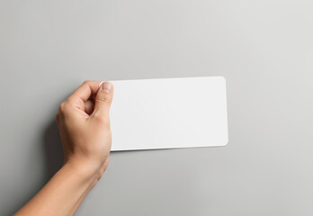Obraz premium Hand sticking white rectangle sticker, grey background, ai generated