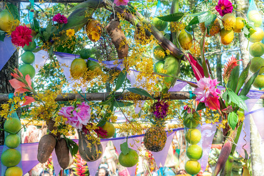 Colorful celebration arch displaying tropical fruit and flowers