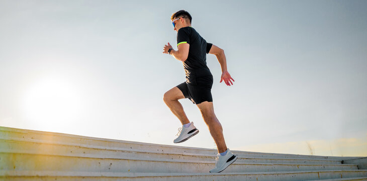 Man runs up steps during sunset at a public park in the early evening