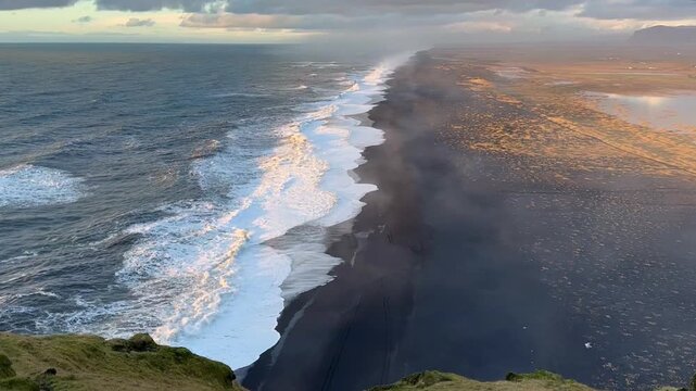 Static shot of black sand beach and Atlantic ocean at sunset from Dyrholaey, Iceland. HD 1080p.