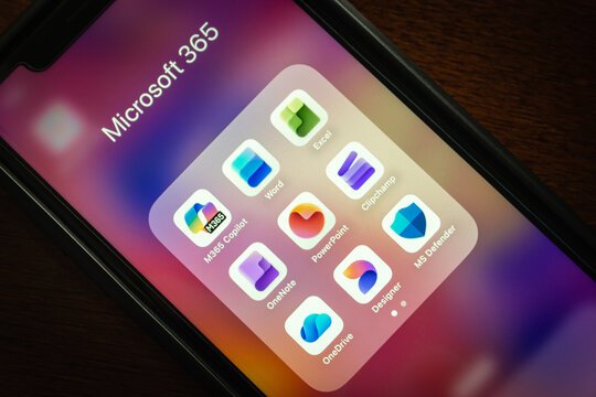 Quito, ECUADOR - Oct 13 2025 : Close-up of a smartphone displaying the Microsoft 365 folder with apps like Word, Excel, PowerPoint, OneDrive, and Copilot.