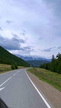 Altai, June 9, 2022: The Chuy Highway is one of the most picturesque roads in the world. A view of the Altai Mountains from a car window. Plains, mountain ranges, and narrow valleys. 4К