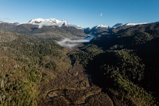 Aerial shot of Pichi Traful River in Patagonia with Andes mountains behind