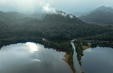 Aerial shot of the bridge over Patagonian Lake in a misty morning