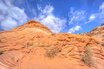 A rocky hillside with a blue sky in the background