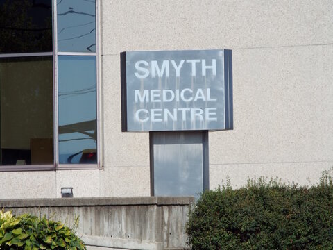 Ottawa, ON, Canada-July 9,2025:The exterior of the "Smyth Medical Centre" features a silver and white sign mounted against a modern concrete building facade on Russell Road.