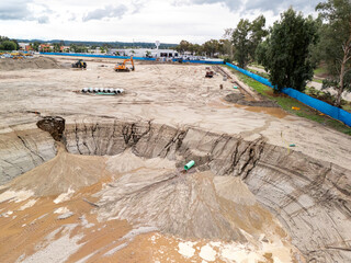 Aerial view of a large-scale construction site with heavy machinery and industrial building progress.ult