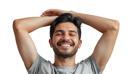 A young man with his hands behind his head smiling joyfully against a black background