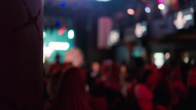 Animation and allure of nightclub scene captured through neon glow and crowded dance space