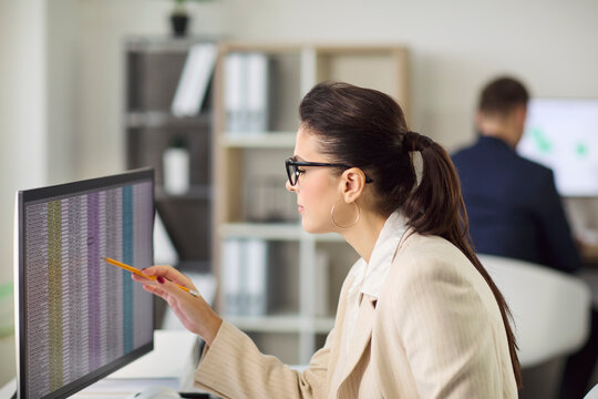 Accountant audit data analysis on computer office. Focused business woman reviews spreadsheets for accurate finance reports. Bright open modern office. Clear concept of accuracy and trust.