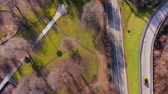 City Roads and Green Spaces: An aerial view showcases the harmonious blend of nature and urban infrastructure, where meandering roads carve through patches of verdant greenery.
