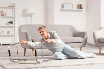 Obraz premium Mature woman with walker falling on floor at home