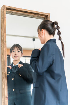 Girls in elementary, junior high, and high school uniforms getting ready in the morning