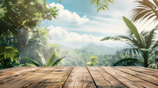 Wooden table foreground with lush tropical foliage and mountain backdrop under blue sky