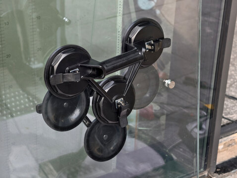 Black Suction Cups Handling Tool on Glass