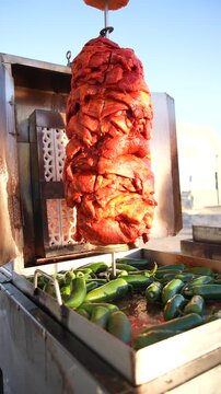 Rotating Al Pastor Pork Cooking on a Traditional Trompo