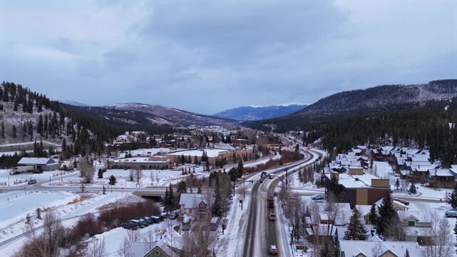 Winter downtown Breck morning main street Breckenridge Ski Resort town Colorado aerial drone Lake Dillon Keystone Rocky Mountains December January cars condos homes business buildings forward
