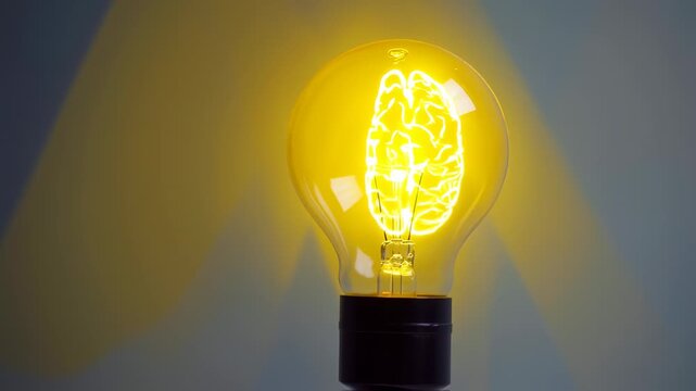 A glowing brain silhouette inside a lightbulb, symbolizing ideas and concepts