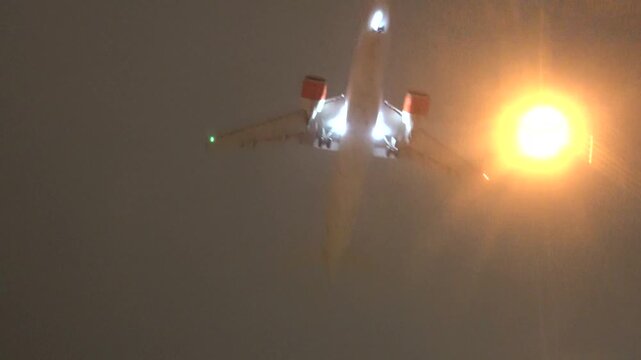 Stockholm, Sweden A plane lands at night in winter on a runway at Arlanda Airport.