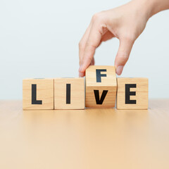 Fototapeta premium hand change wooden block Live to Life. Lifestyle, Live your life, learning, motivation and mindset concepts