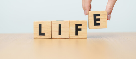 Fototapeta premium hand change wooden block Live to Life. Lifestyle, Live your life, learning, motivation and mindset concepts