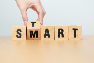 hand change wooden block Start to Smart. Intelligent, Clever, Beginning, Startup, Growth and New...