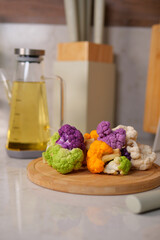 Colorful cauliflower on a wooden cutting board
