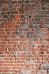 Red and gray brick wall with rough texture
