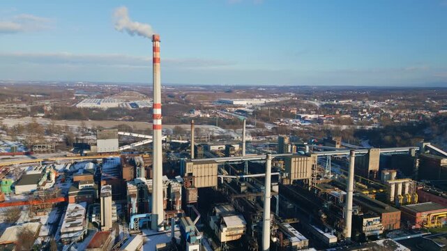 Smoke stacks pollute winter sky from industrial coking plant Ostrava AERIAL
