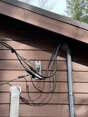A powerline mounted to a wood siding
