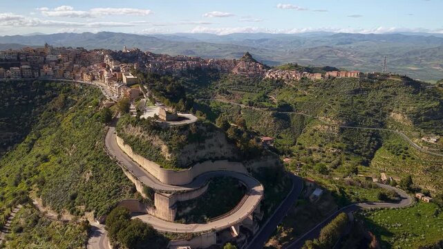 Aerial view approaching winding roads leading to Centuripe Sicilian hill town on lush Mount Etna