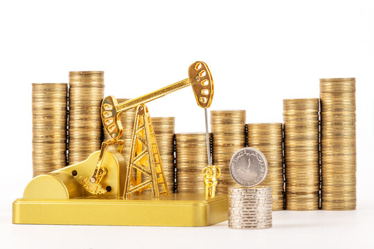 Gold oil pump and 1 United Arab Emirates dirham coin on white background