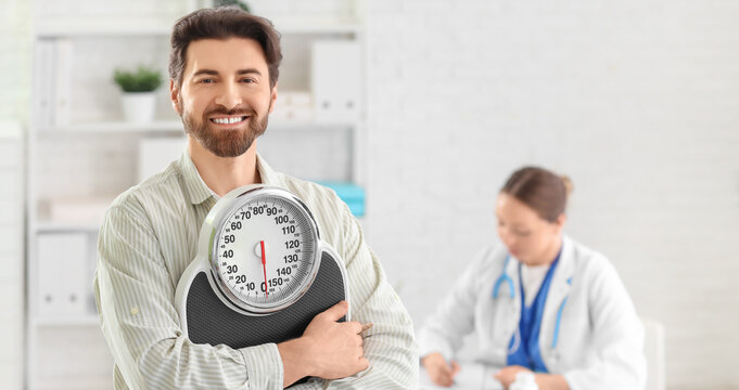 Young man with weight scales at nutritionist's office
