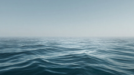 Fototapeta premium An expanse of blue ocean meeting the serene sky, with gentle waves rippling across the surface, creating a tranquil atmosphere.