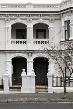 Elegant Victorian terrace house facade with ornate architectural details and arched doorways in Hobart, Tasmania