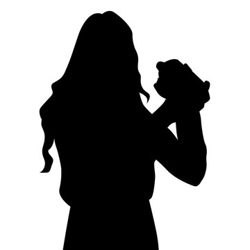 silhouette of a female bartender shakes a drink with both hands.