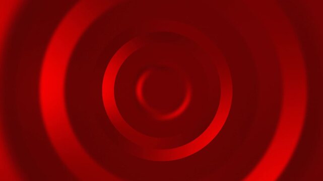 A close-up view of concentric red circles forming a spiral pattern on a vibrant red background, creating a dynamic and abstract visual effect