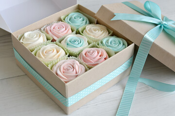 Zephyr marshmallow flowers in gift box, pastel tones, cozy handmade sweets concept