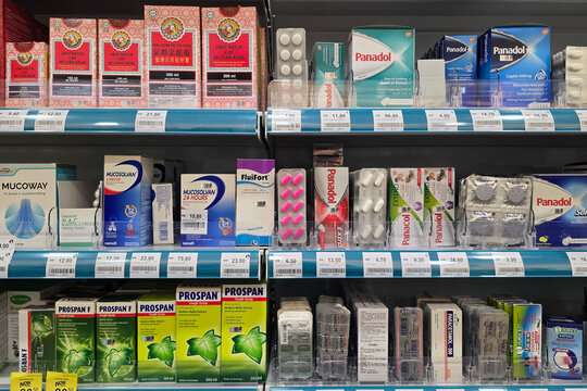 Penang, Malaysia &ndash; Nov 22, 2025: Over-the-counter cough syrup, pain relief tablets, and cold medicines displayed on a pharmacy shelf, featuring a variety of branded healthcare products.