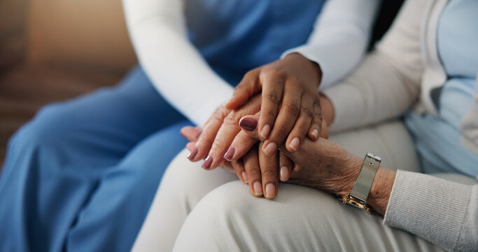 Caregiver, holding hands and people in home with comfort, understanding or empathy in assisted living. Compassion, patient security or nurse with elderly woman, support and trust in retirement care.