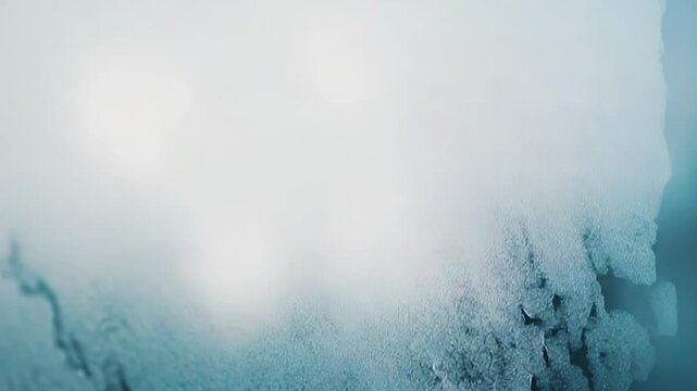 Condensed water droplets creating unique frozen patterns and a frosty ice texture on a surface, providing an abstract cold weather background with blue and white tones