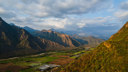 Aerial drone panoramic sunset landscape of Mayasc&oacute;n, Lambayeque, with mountains and rural fields in northern Peru, ideal for social media, marketing, graphic design, and scenic wallpapers