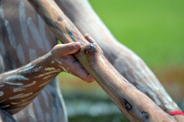 Indigenous Australians man play Aboriginal music with didgeridoo wind instrument