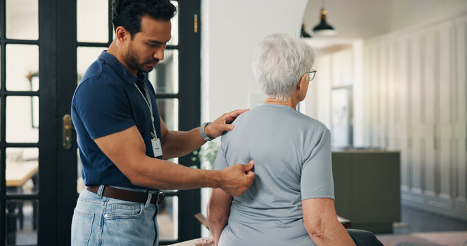 Old woman, chiropractor and consultation in nursing home with back pain, support or rehabilitation. Senior person, orthopedic worker and check in retirement center for spine injury, recovery or help.